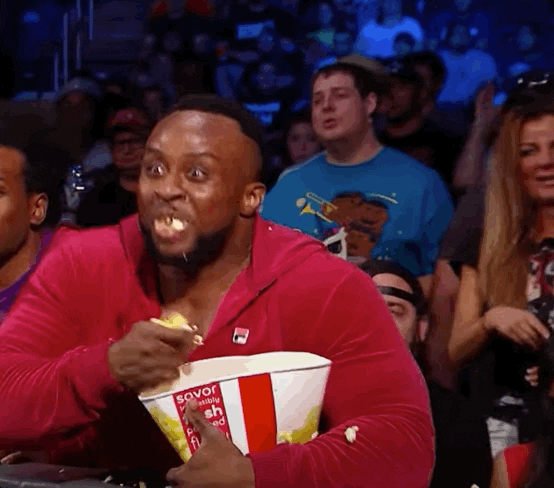 A gif of Big E from WWE eating popcorn enthusiastically.